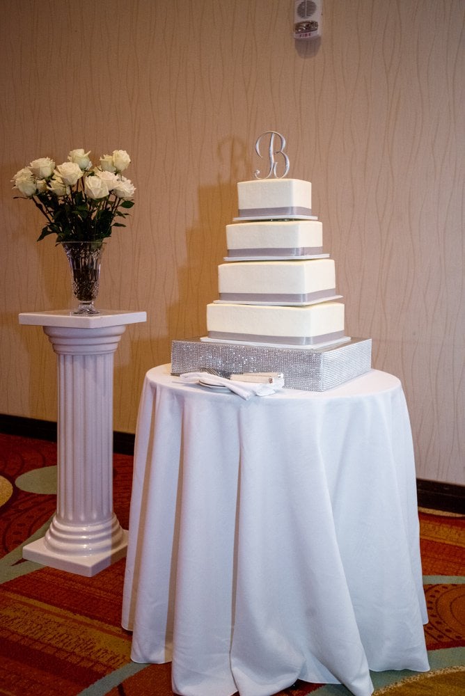 a tiered wedding cake on a foam stand