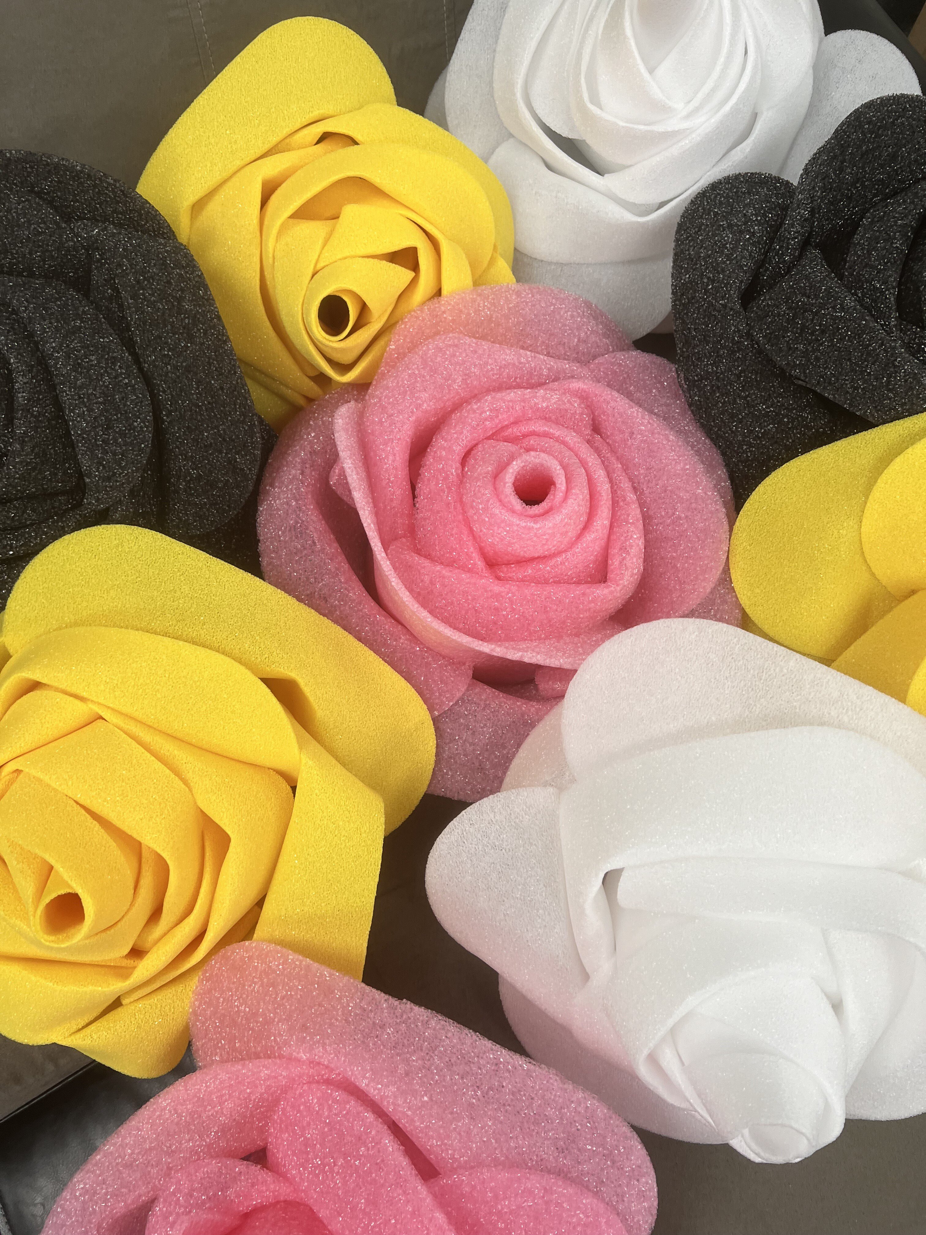 a pile of colorful roses made out of foam